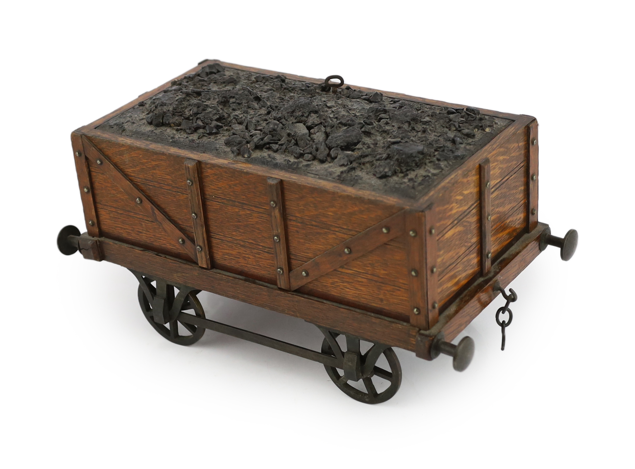 An Edwardian novelty oak smoker's compendium modelled as a railway tender, 34cm wide, 17cm deep, 17cm high